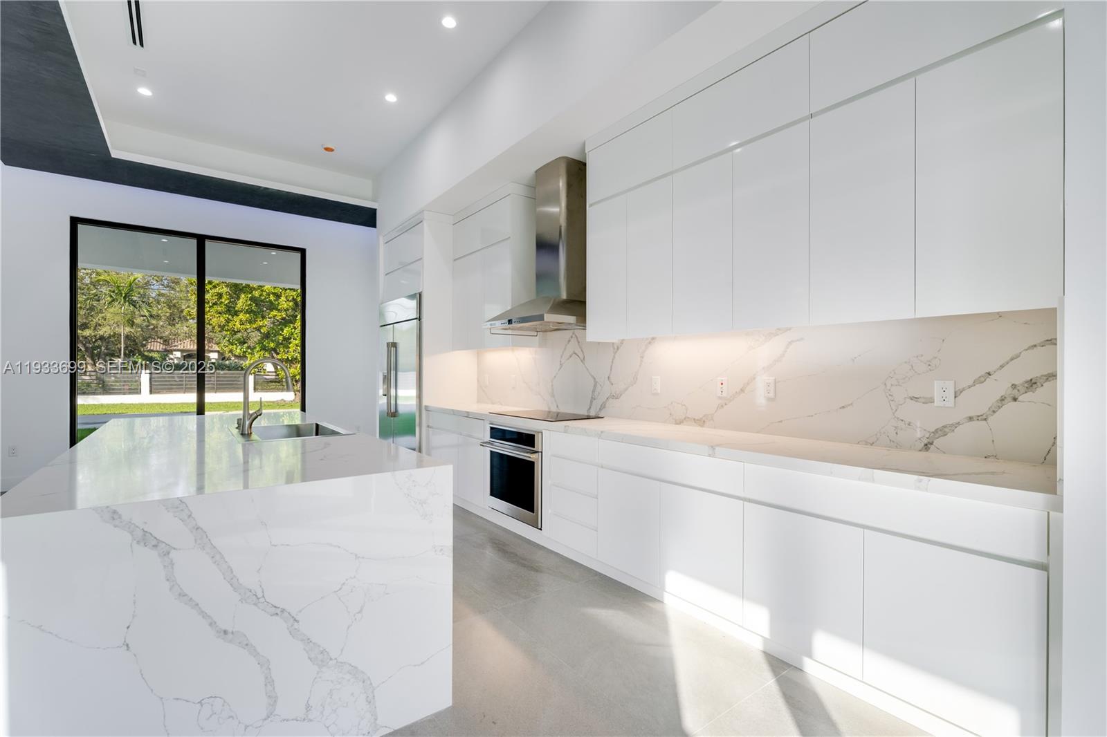 10398 Southwest 64th Street Miami, FL 33173 - Photo 32 of 88 a spacious bedroom with a large bed and a large window