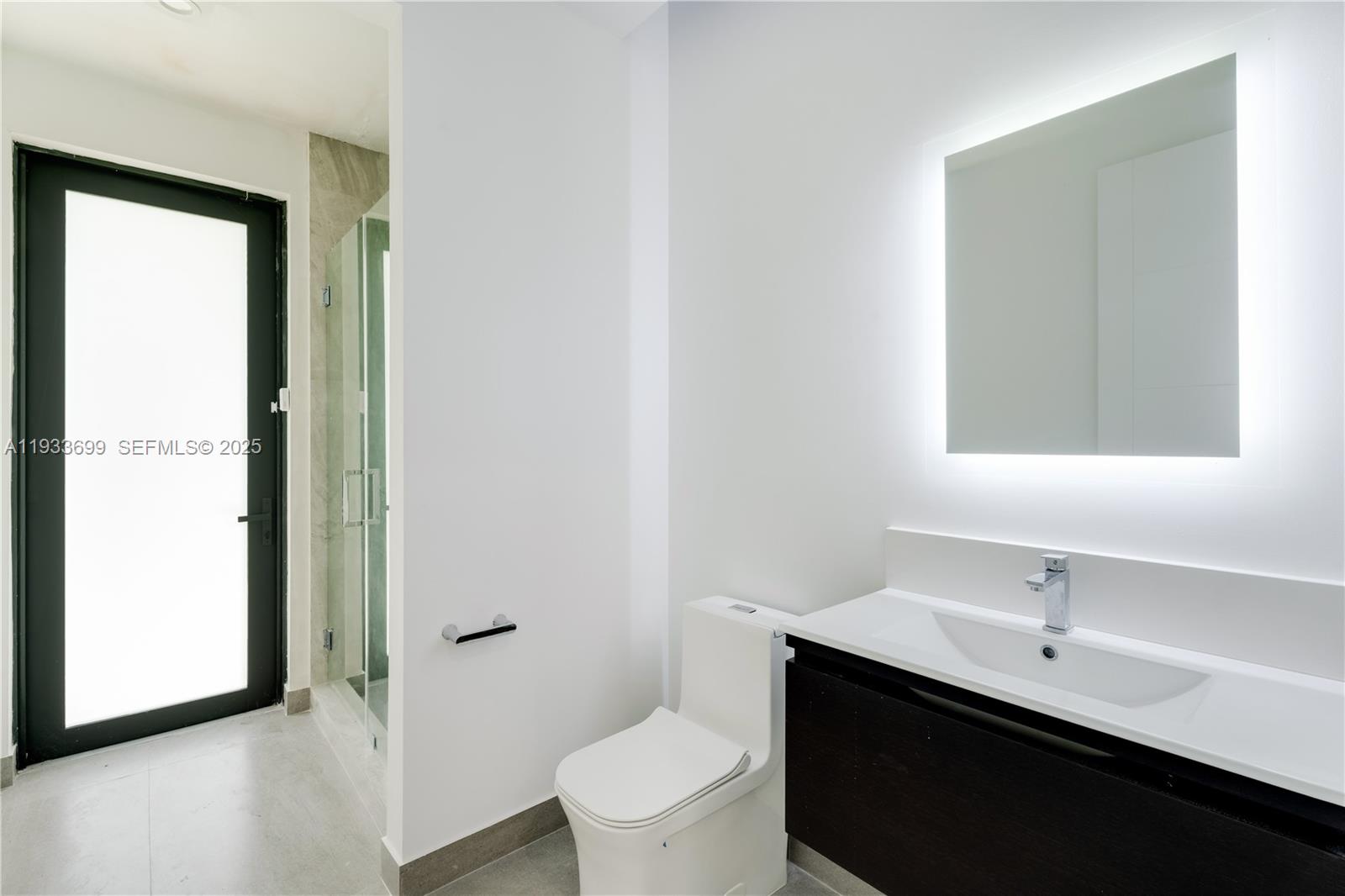 10398 Southwest 64th Street Miami, FL 33173 - Photo 33 of 88 a bathroom with a toilet a sink a mirror and a window