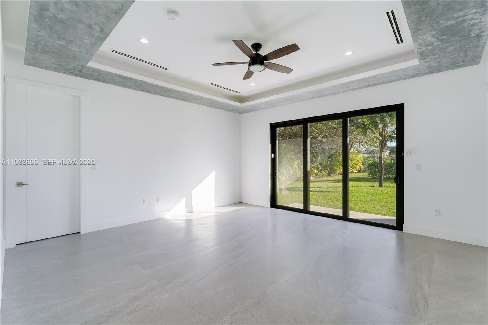 10398 Southwest 64th Street Miami, FL 33173 - Photo 35 of 88 an empty room with ceiling fan and windows