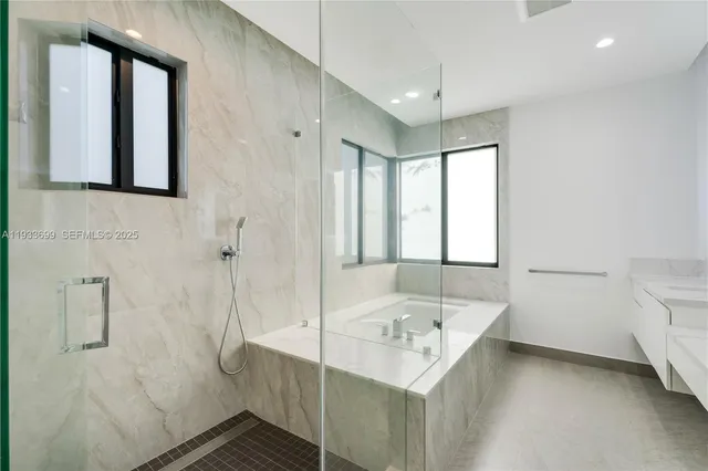 a view of an empty room with wooden floor and window