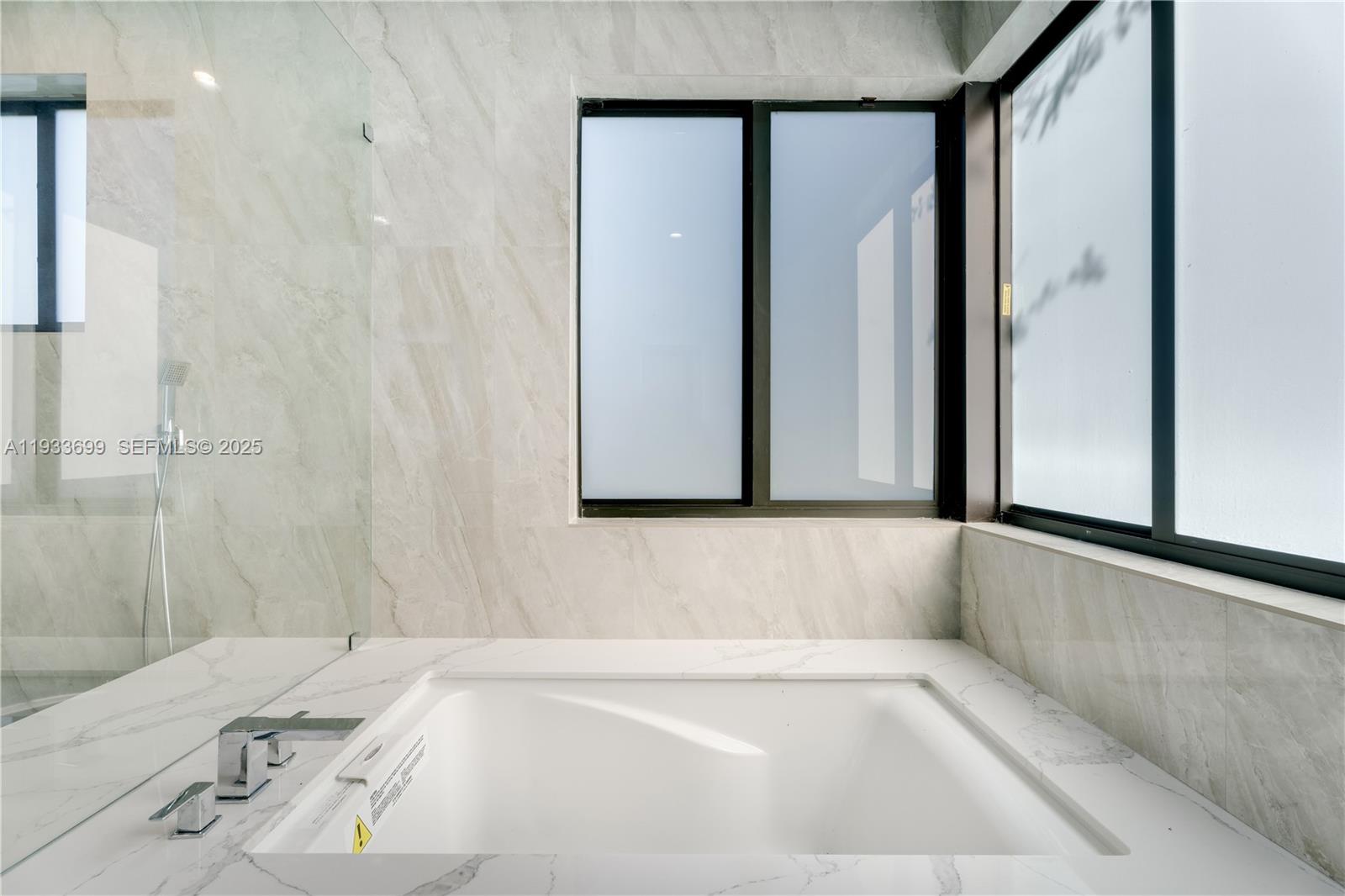 10398 Southwest 64th Street Miami, FL 33173 - Photo 39 of 88 a bathroom with a bathtub and a shower