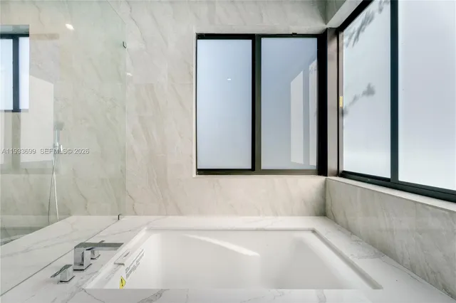 a view of a house with a yard and potted plants