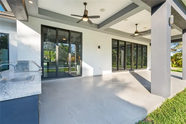 an aerial view of residential house with an outdoor space and seating