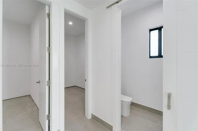 an aerial view of residential houses with outdoor space and pool