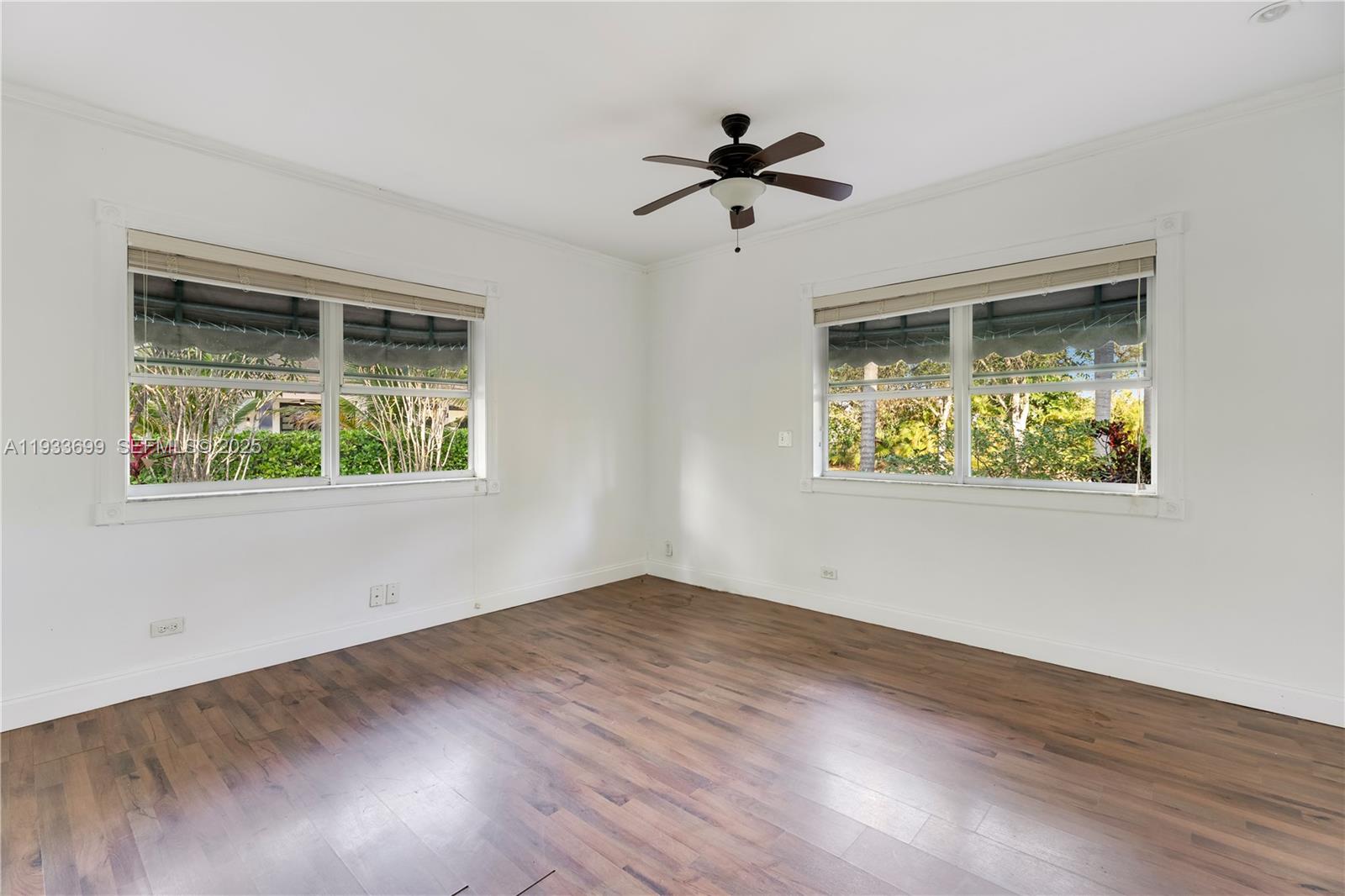 10398 Southwest 64th Street Miami, FL 33173 - Photo 72 of 88 a view of an empty room with wooden floor and a window