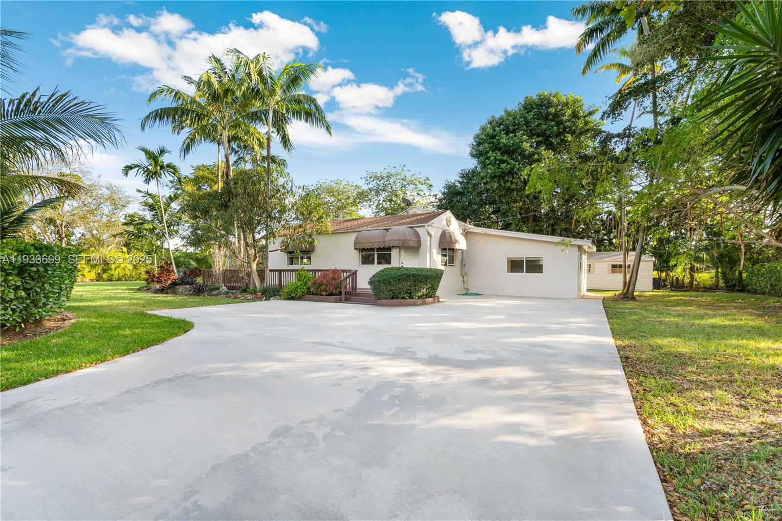 10398 Southwest 64th Street Miami, FL 33173 - Photo 76 of 88 a front view of a house with a yard and trees