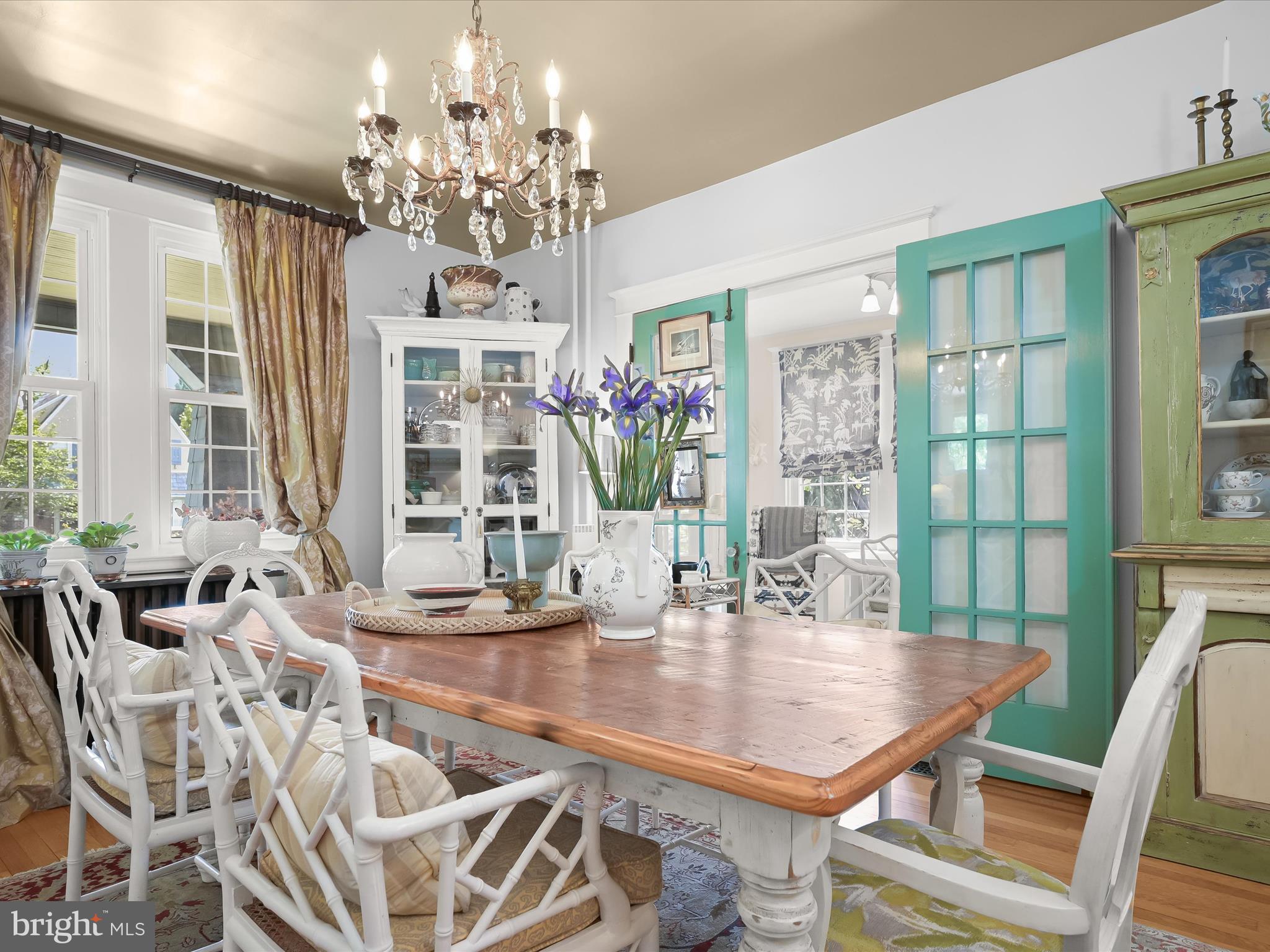 112 Park Drive Baltimore, MD 21228 - Photo 14 of 86 a dining room with wooden floor a chandelier a wooden table and chairs