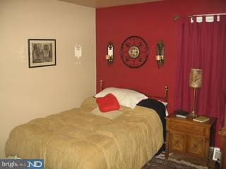 42 Paul Road Maple Shade, NJ 08052 - Photo 3 of 6 a bedroom with a bed and a lamp on dresser