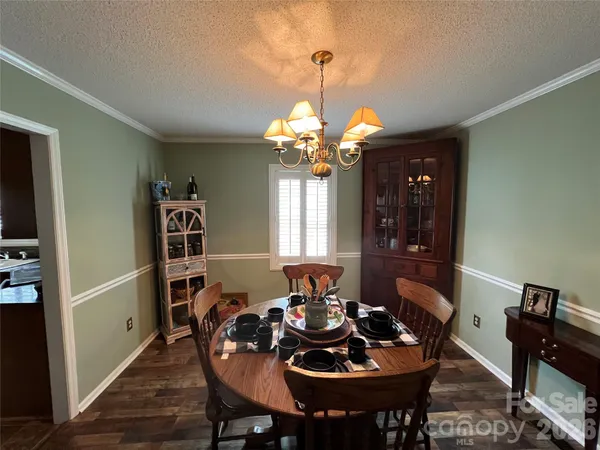 a view of a dining room with furniture and window