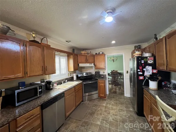 a kitchen with a sink stove top oven and cabinets