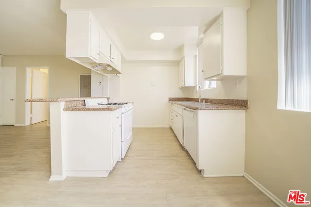 a kitchen with stainless steel appliances granite countertop a sink and a stove