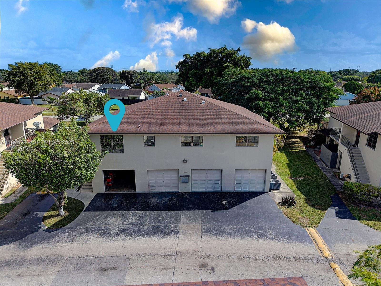 a aerial view of a house with a yard and plants