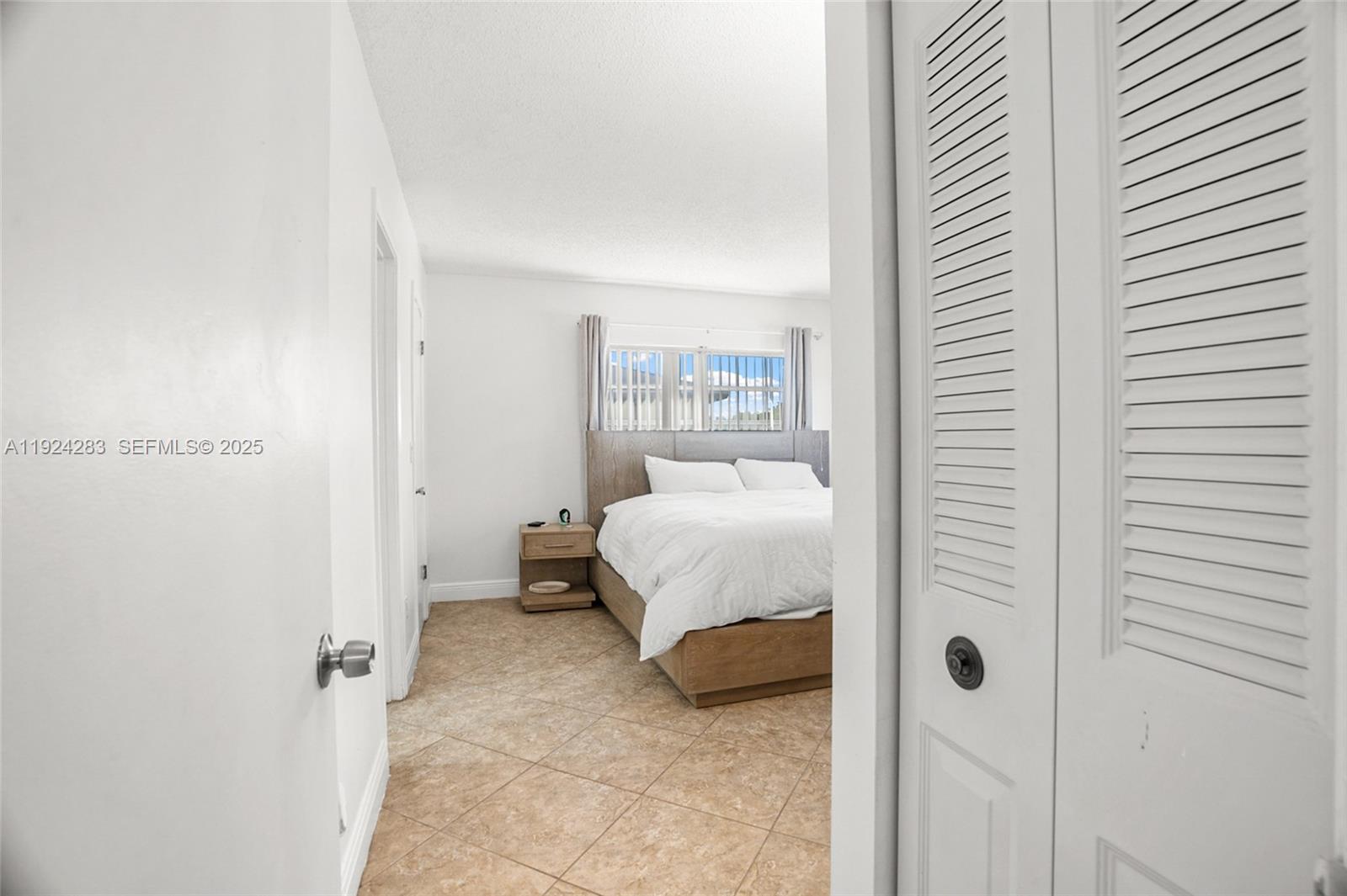 4605 Southwest 139th Court, Unit 814 Miami, FL 33175 - Photo 13 of 27 a bedroom with a bed and a window