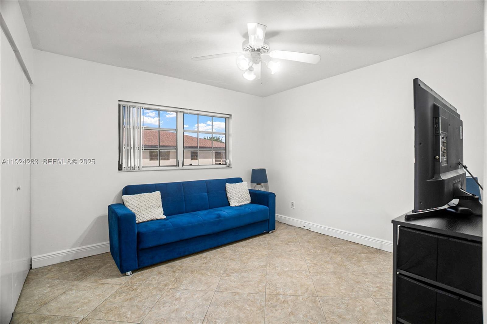 4605 Southwest 139th Court, Unit 814 Miami, FL 33175 - Photo 15 of 27 a living room with furniture and a flat screen tv
