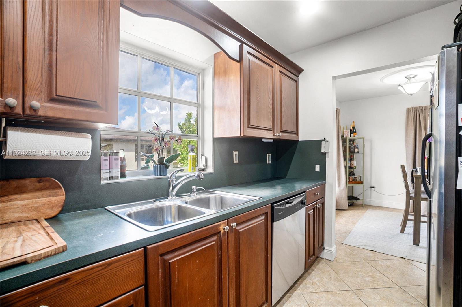 4605 Southwest 139th Court, Unit 814 Miami, FL 33175 - Photo 8 of 27 a kitchen with stainless steel appliances granite countertop a sink refrigerator and cabinets