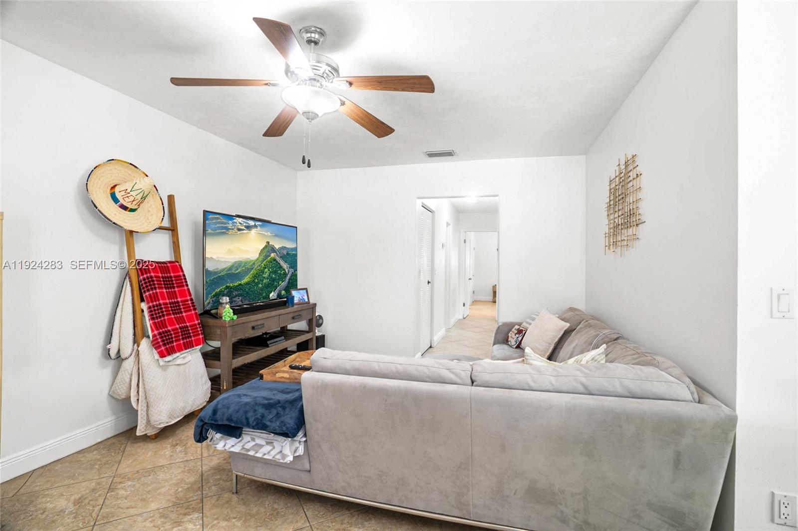 4605 Southwest 139th Court, Unit 814 Miami, FL 33175 - Photo 9 of 27 a living room with furniture and a flat screen tv