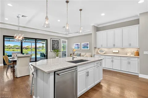 a kitchen with a sink stove and cabinets