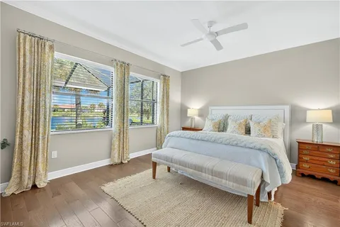 a spacious bedroom with a bed and a large window