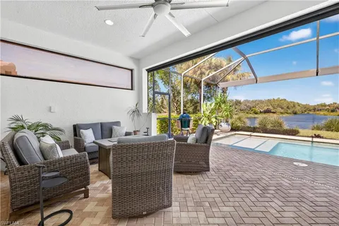 a living room with fireplace furniture and a large window