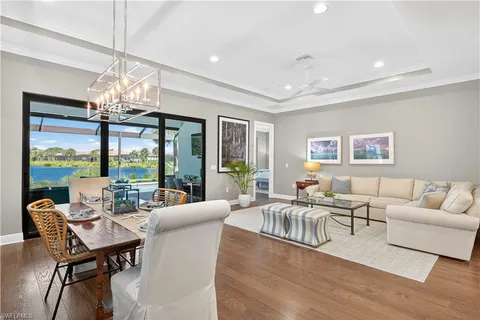 a living room with furniture and a chandelier