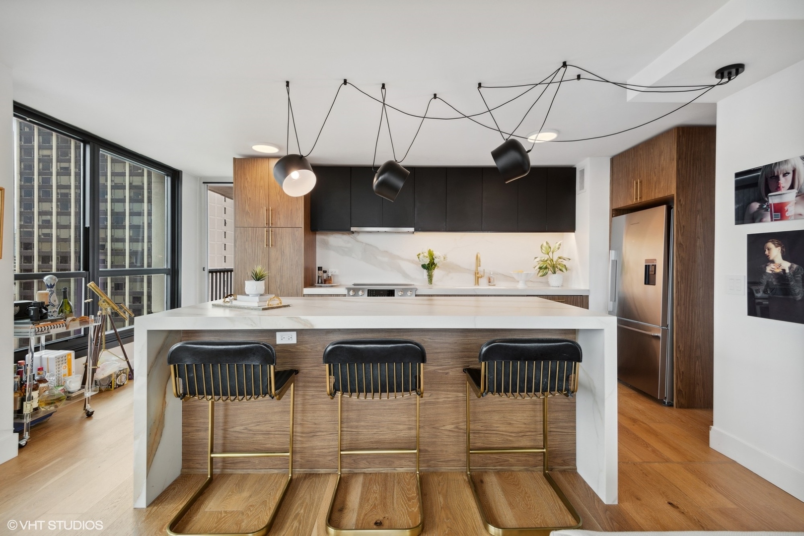 1030 North State Street, Unit 21E Chicago, IL 60610 - Photo 15 of 42 a kitchen with a sink a refrigerator and chairs