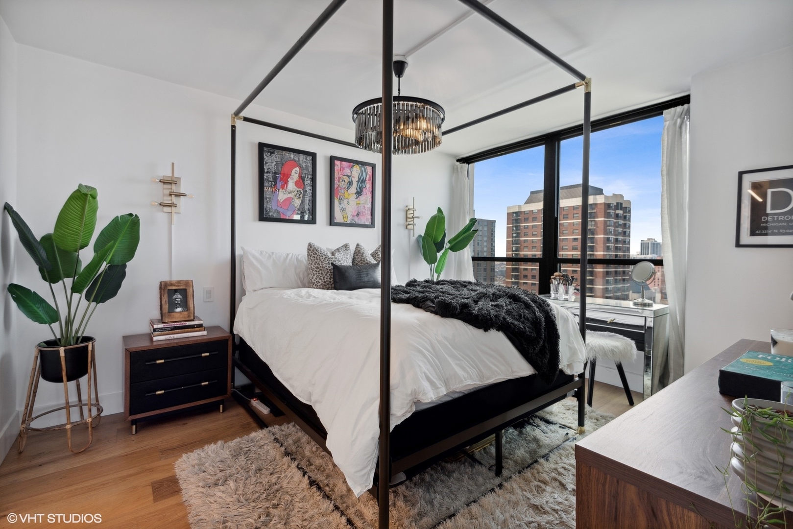 1030 North State Street, Unit 21E Chicago, IL 60610 - Photo 20 of 42 a bedroom with a bed a chandelier and a potted plant