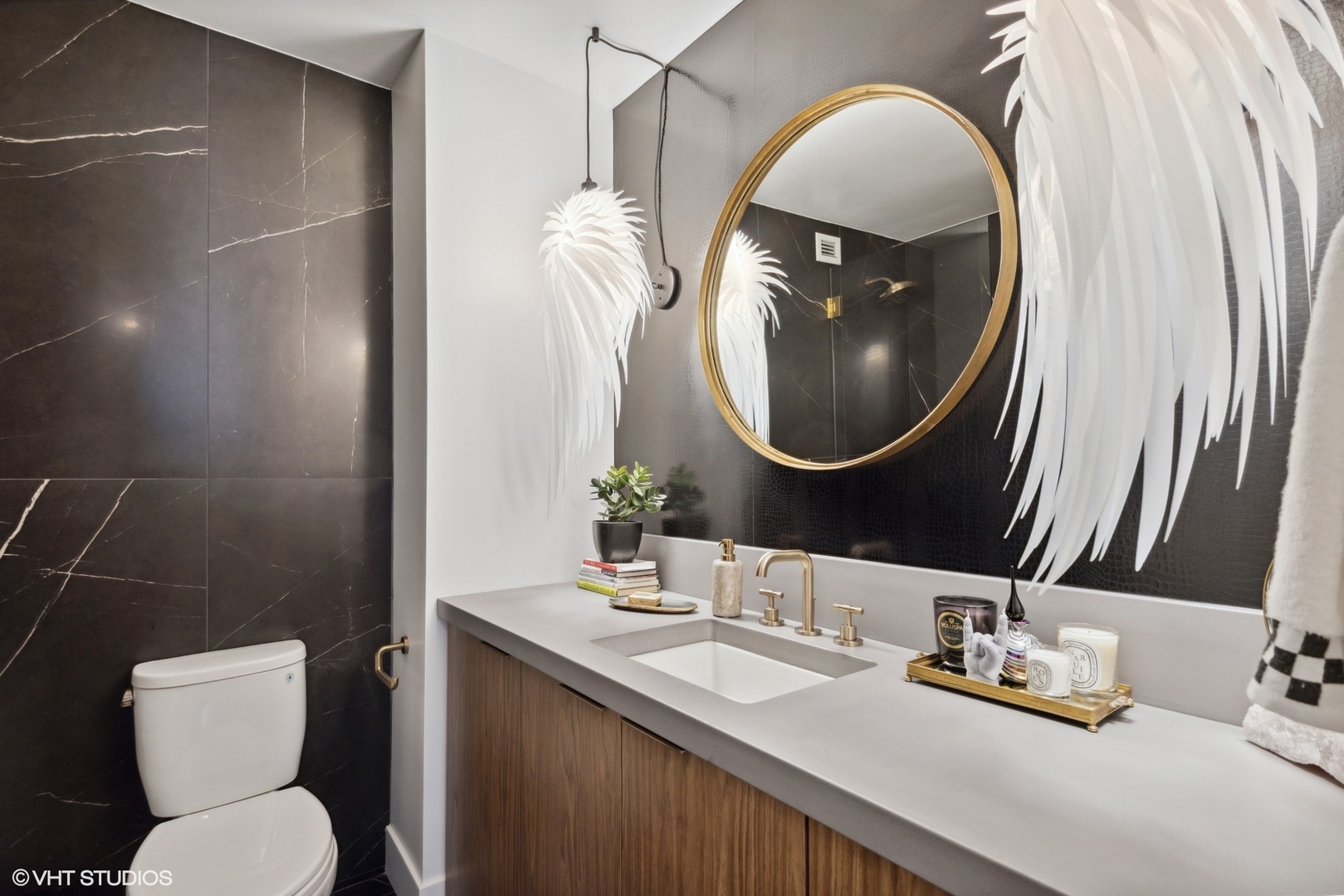 1030 North State Street, Unit 21E Chicago, IL 60610 - Photo 24 of 42 a bathroom with a toilet sink vanity and mirror