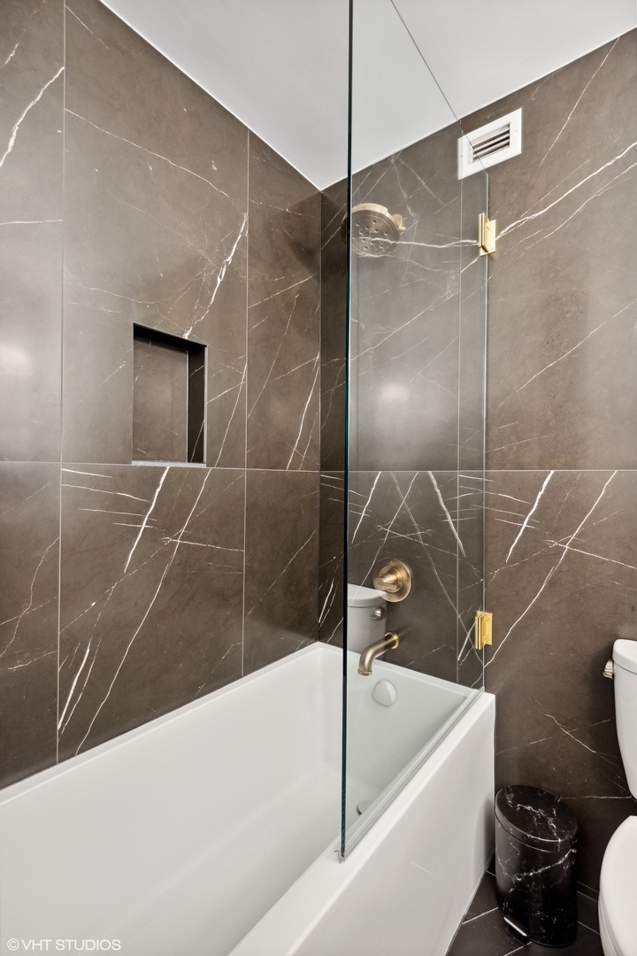 1030 North State Street, Unit 21E Chicago, IL 60610 - Photo 25 of 42 a bathroom with a bathtub and a shower