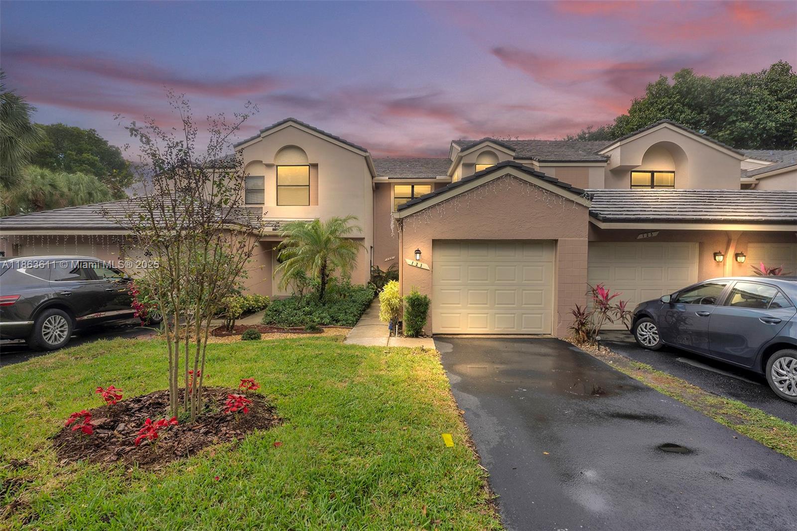 a front view of a house with a yard and garage