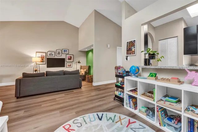a living room with furniture and a book shelf