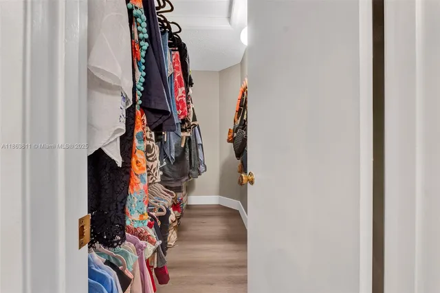 a view of walk in closet with clothes