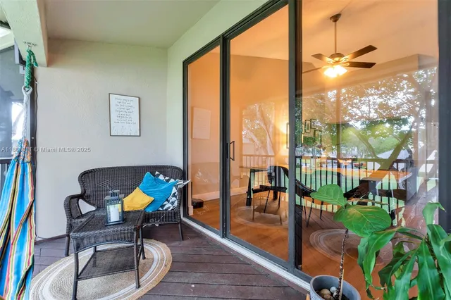a dining room with furniture and a floor to ceiling window