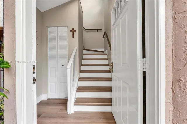 a view of entryway with wooden floor and stairs