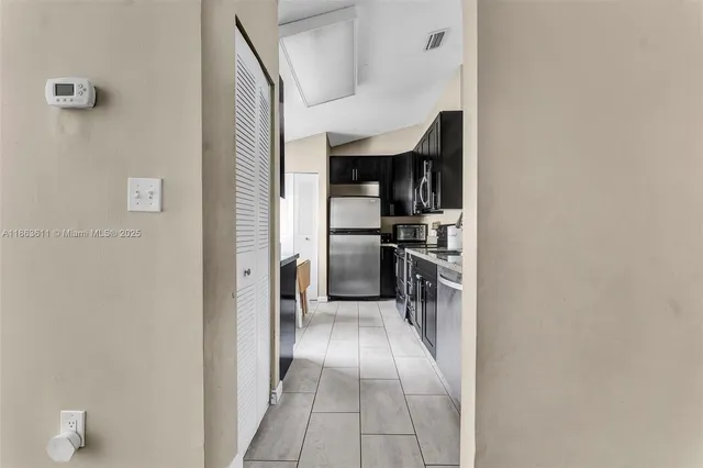a view of a kitchen from the hallway