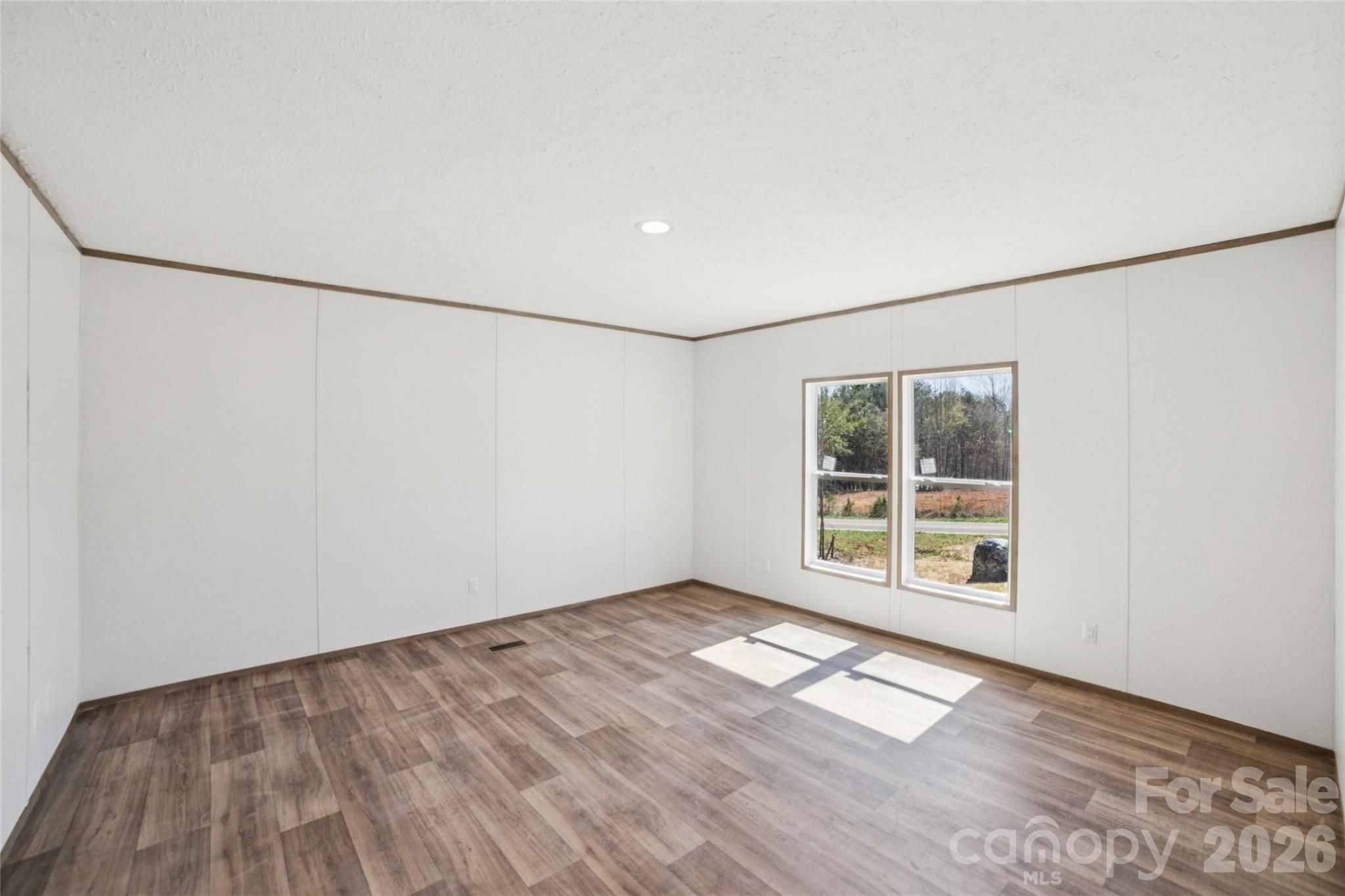 5350 Hope Road Vale, NC 28168 - Photo 13 of 24 an empty room with wooden floor and windows
