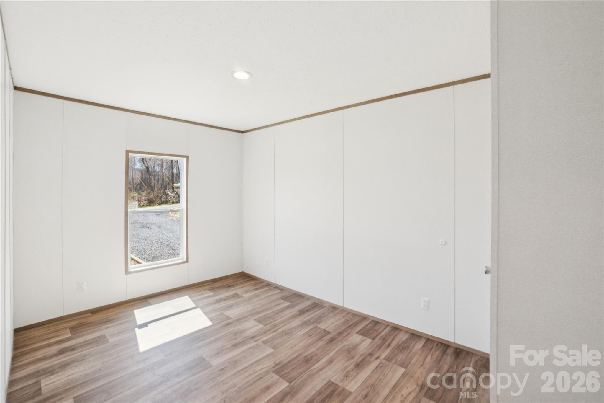 5350 Hope Road Vale, NC 28168 - Photo 19 of 24 a view of an empty room with wooden floor and a window