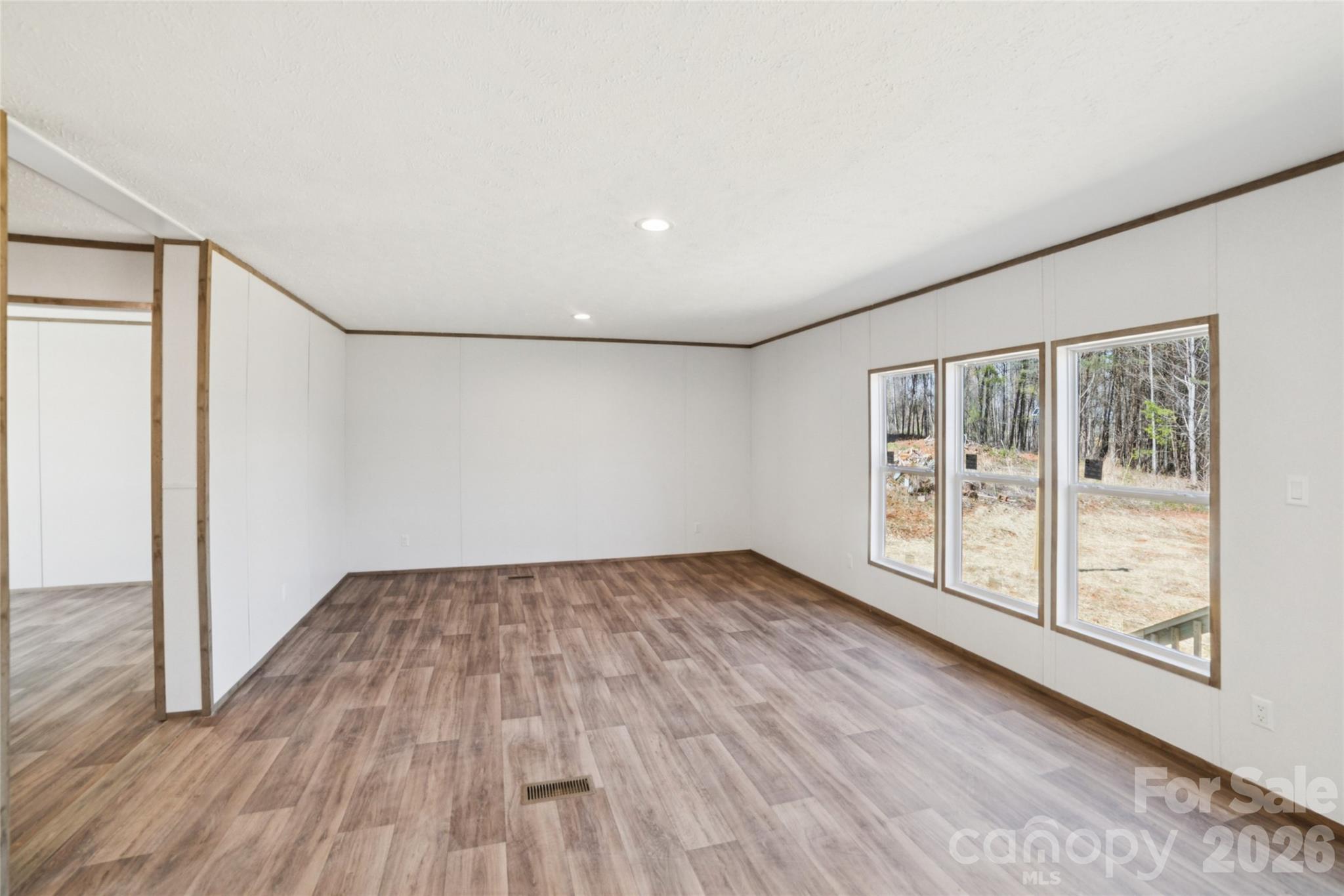 5350 Hope Road Vale, NC 28168 - Photo 3 of 24 a view of an empty room with wooden floor and a window