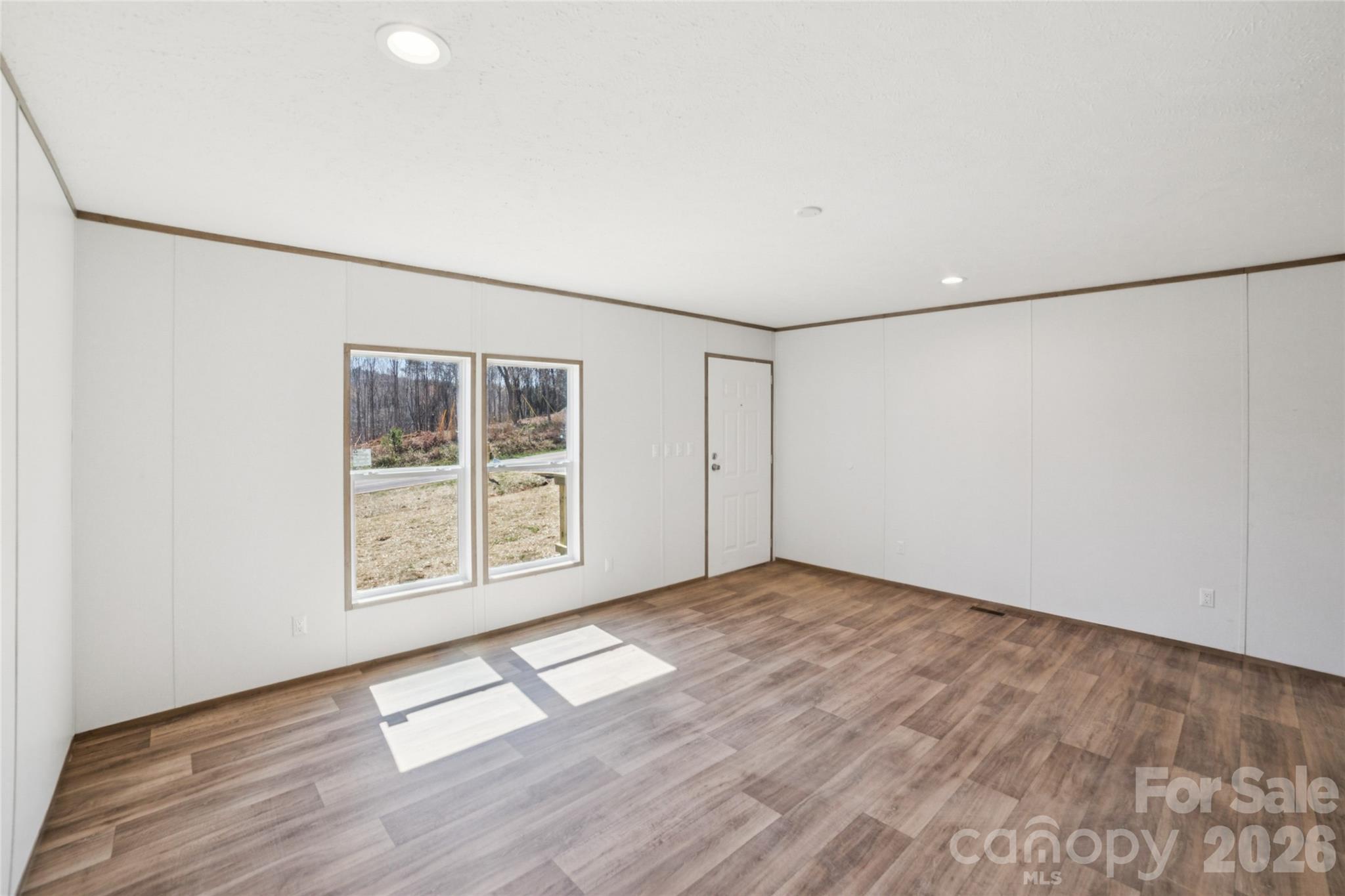 5350 Hope Road Vale, NC 28168 - Photo 4 of 24 an empty room with wooden floor and windows