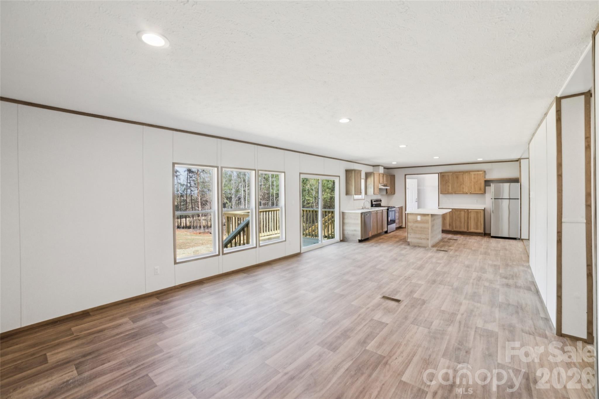 5350 Hope Road Vale, NC 28168 - Photo 5 of 24 a view of an empty room with wooden floor and a window