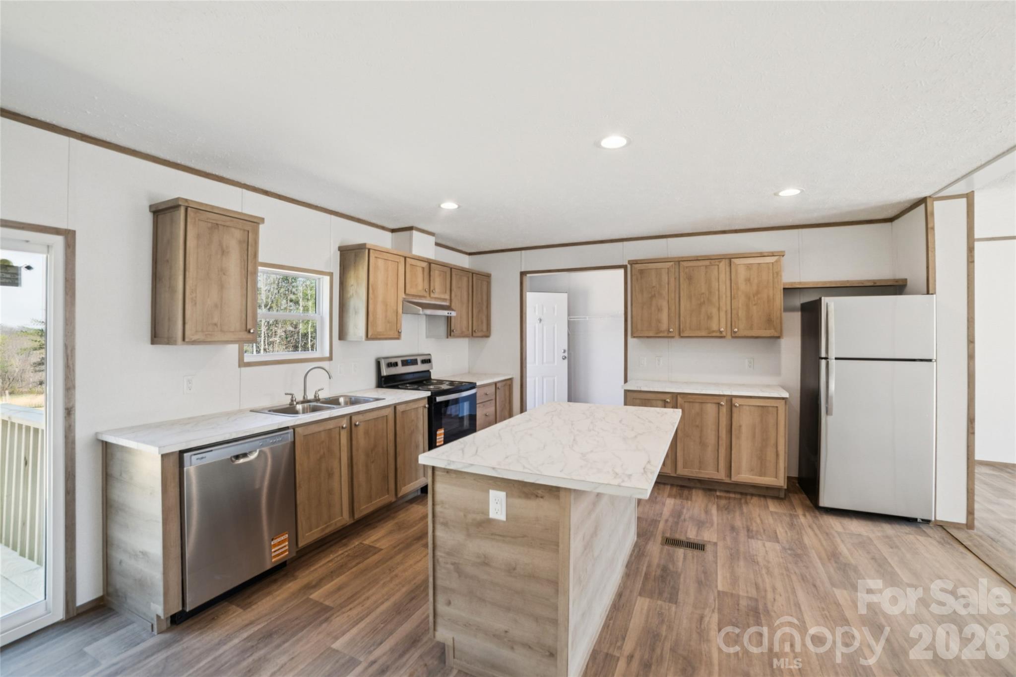 5350 Hope Road Vale, NC 28168 - Photo 7 of 24 a large kitchen with a counter top space a sink stainless steel appliances and cabinets