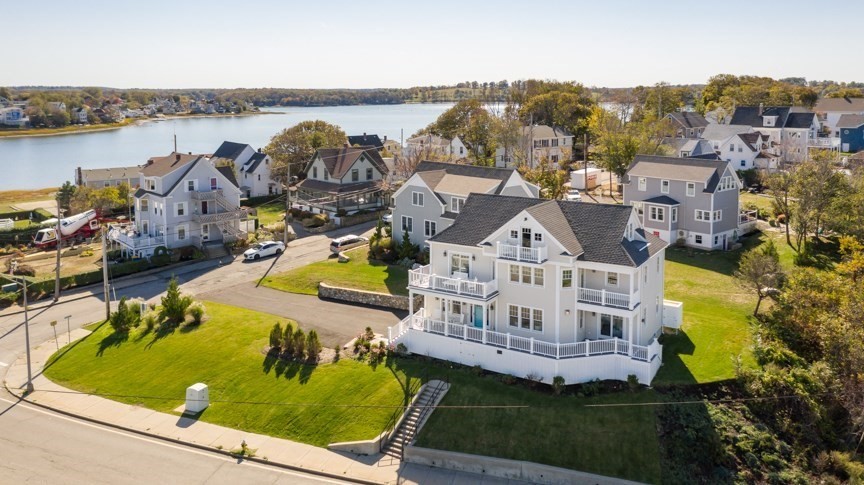 an aerial view of a house with a garden and lake view