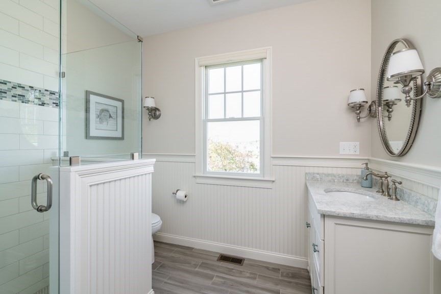 10 Whitehead Avenue Hull, MA 02045 - Photo 17 of 37 a bathroom with a granite countertop sink a shower and a mirror
