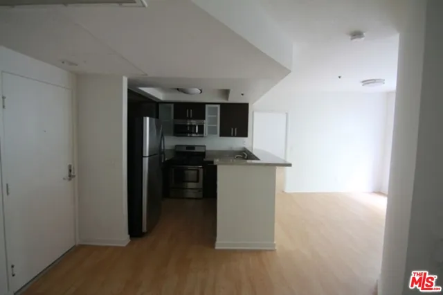 a kitchen with stainless steel appliances a refrigerator and a stove top oven