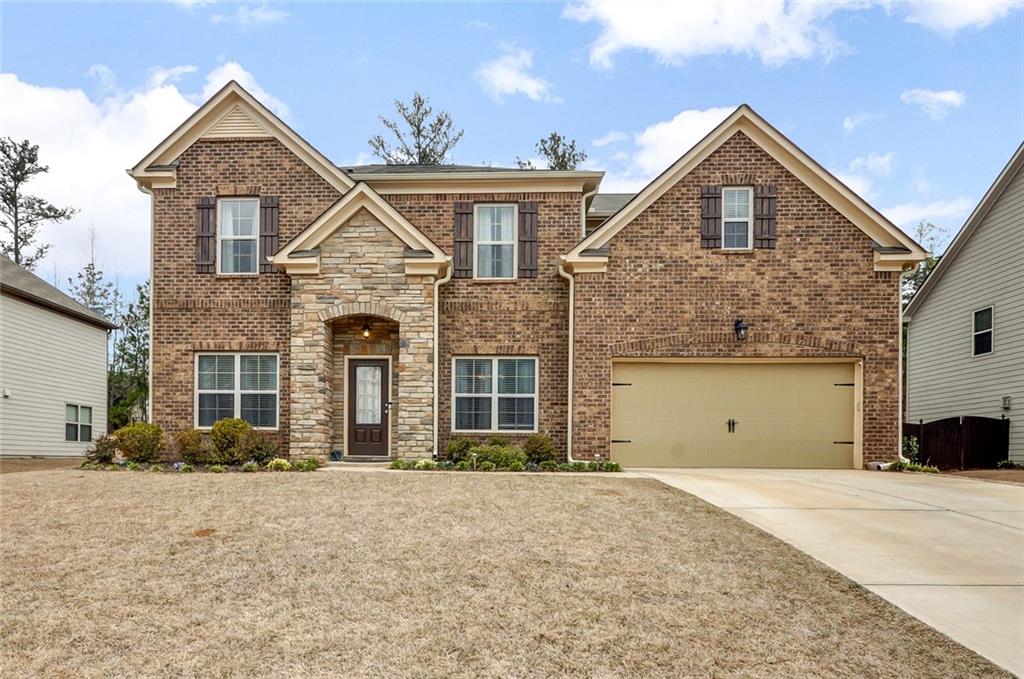 a front view of a house with a yard