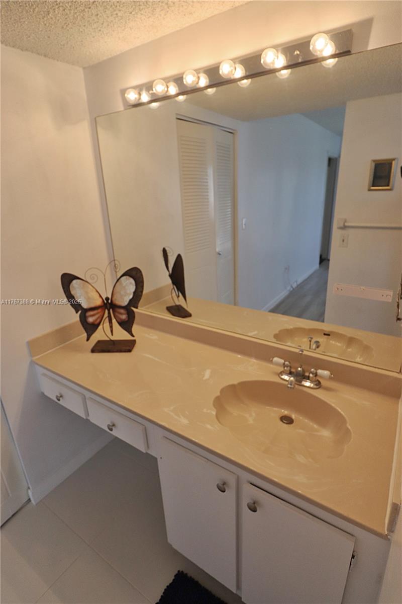 1206 North Hiatus Road, Unit 1206 Pembroke Pines, FL 33026 - Photo 11 of 18 a bathroom with a sink and mirror