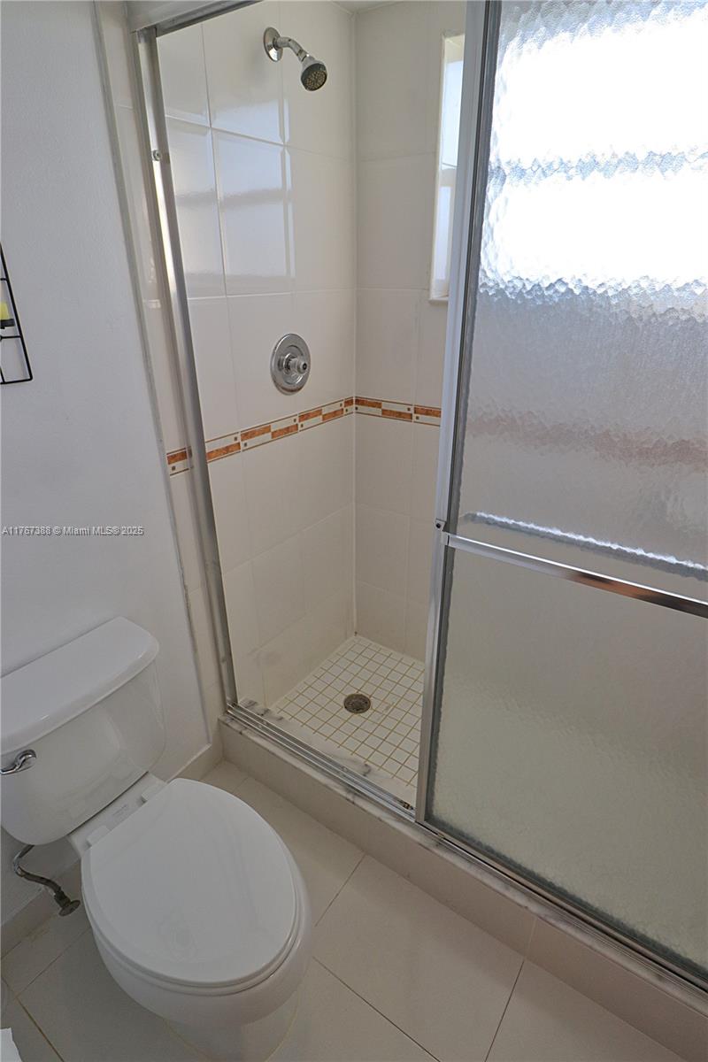 1206 North Hiatus Road, Unit 1206 Pembroke Pines, FL 33026 - Photo 12 of 18 a bathroom with a toilet and a shower