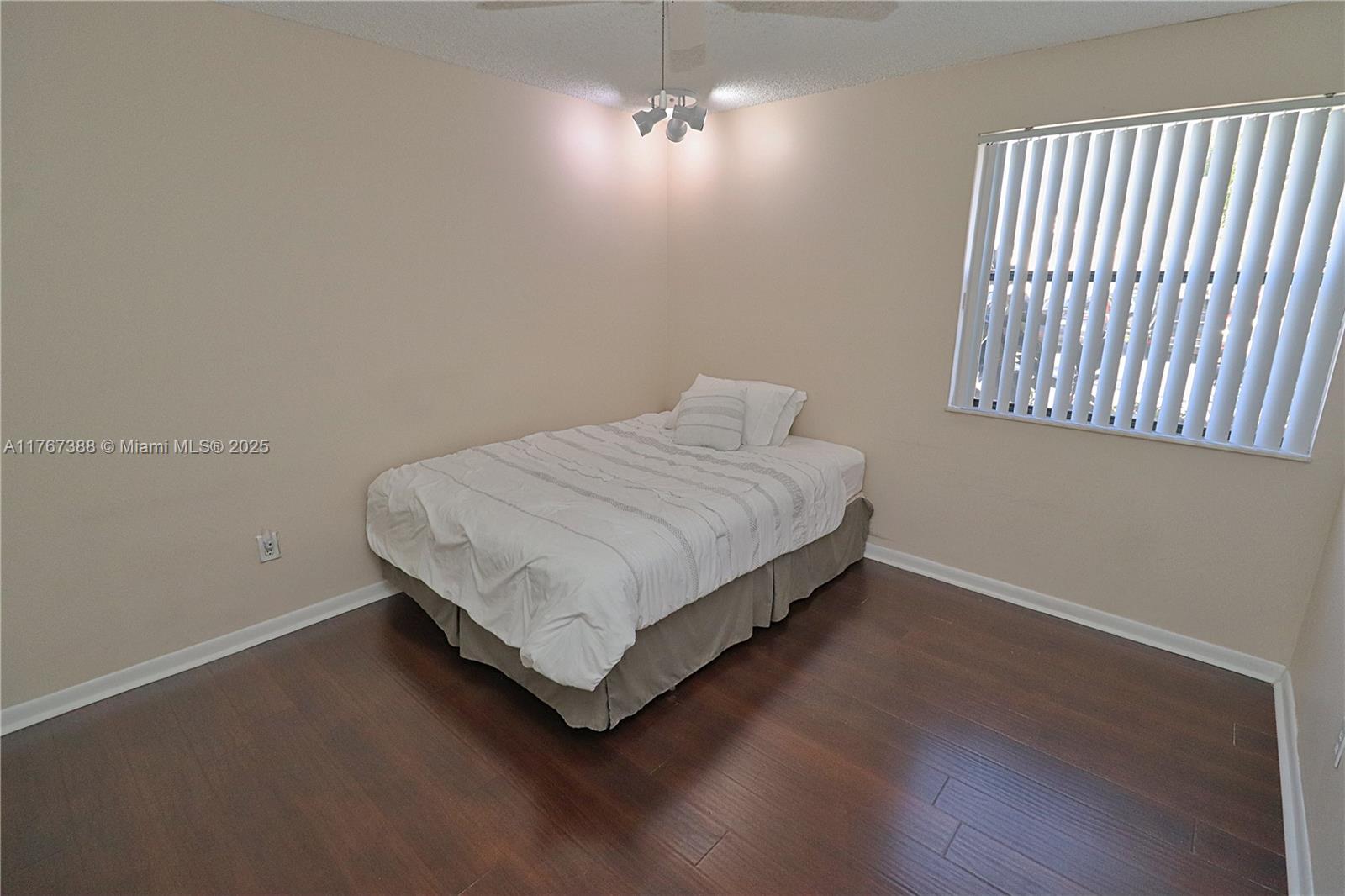 1206 North Hiatus Road, Unit 1206 Pembroke Pines, FL 33026 - Photo 13 of 18 a bedroom with a bed and a window