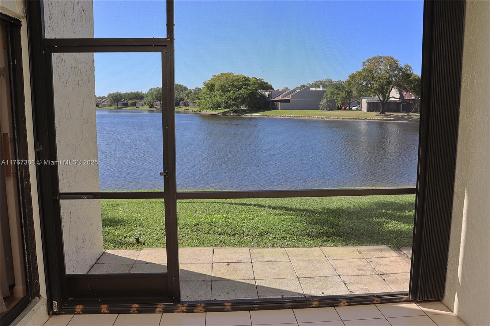 1206 North Hiatus Road, Unit 1206 Pembroke Pines, FL 33026 - Photo 15 of 18 a view of a yard from a window