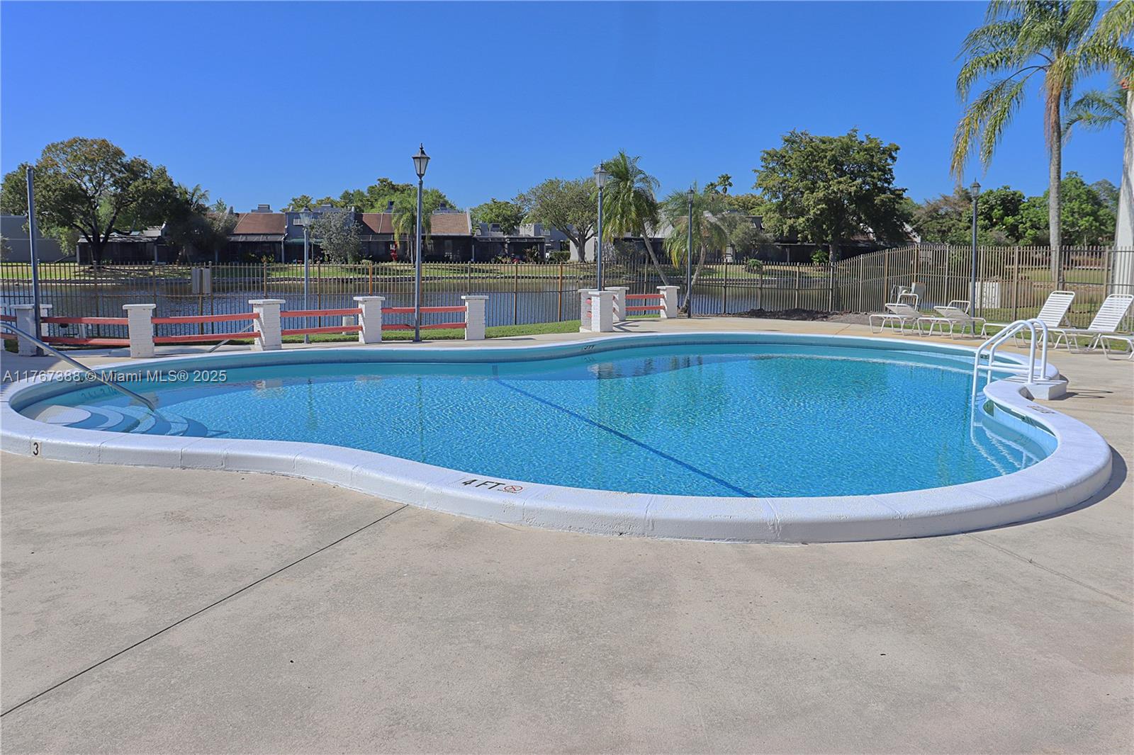 1206 North Hiatus Road, Unit 1206 Pembroke Pines, FL 33026 - Photo 17 of 18 a view of a lake with outdoor space