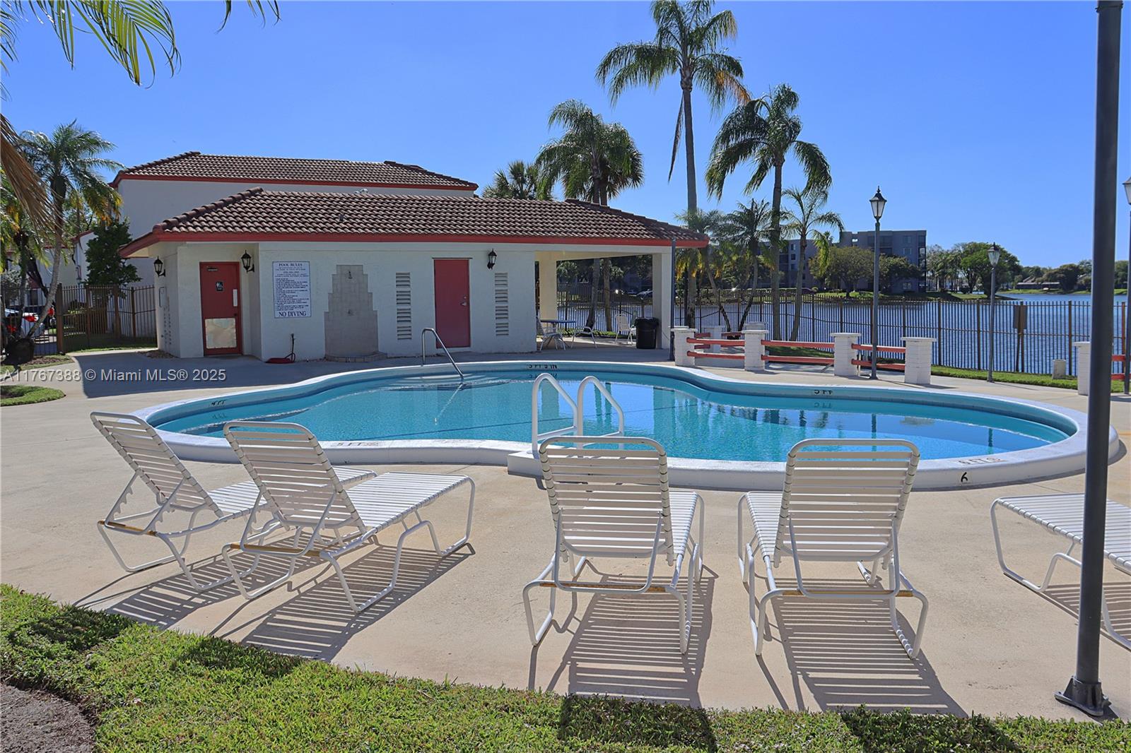 1206 North Hiatus Road, Unit 1206 Pembroke Pines, FL 33026 - Photo 18 of 18 a patio with a table and chairs and a barbeque